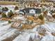 Aerial view of a large home with a landscaped yard, patio, and snow-covered surroundings at 7186 Weaver Cir, Castle Rock, CO 80104