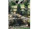 Backyard waterfall feature with plants and rocks, with a glimpse of the home's exterior at 7186 Weaver Cir, Castle Rock, CO 80104