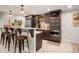 Stylish bar area with modern cabinetry, marble countertop, and seating for a perfect entertaining space at 7186 Weaver Cir, Castle Rock, CO 80104