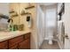 Cozy bathroom featuring neutral wall colors, decorative shelving, vanity with mirror and toilet area at 7186 Weaver Cir, Castle Rock, CO 80104