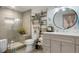 Modern bathroom featuring a glass-enclosed shower and stylish vanity with a round mirror at 7186 Weaver Cir, Castle Rock, CO 80104