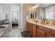 Lovely bathroom with and sinks, shower, and a view into the main bedroom at 7186 Weaver Cir, Castle Rock, CO 80104