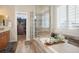 Beautiful bathroom featuring glass enclosed shower, soaking tub, and walk in closet at 7186 Weaver Cir, Castle Rock, CO 80104