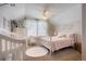 Adorable pink-themed bedroom with sloped ceilings, crib, dresser, and a big window at 7186 Weaver Cir, Castle Rock, CO 80104
