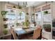 Cozy dining area with a large window, hanging plants, and comfortable seating at 7186 Weaver Cir, Castle Rock, CO 80104