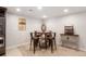 Casual dining area with a round table, upholstered stools, neutral carpet, and a decorative buffet at 7186 Weaver Cir, Castle Rock, CO 80104