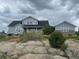 Two story home with a charming exterior and views of the surrounding nature and rock outcroppings at 7186 Weaver Cir, Castle Rock, CO 80104