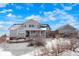 Charming two-story home with a covered porch, snow on the ground, and a separate garage at 7186 Weaver Cir, Castle Rock, CO 80104