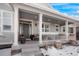 Inviting front porch with columns and seating, creating a welcoming entrance at 7186 Weaver Cir, Castle Rock, CO 80104