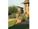 Beautifully landscaped front yard with mature trees, rock features and a deer near the house at 7186 Weaver Cir, Castle Rock, CO 80104