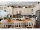 Well-lit kitchen with a large granite island, stainless steel appliances, and light-colored cabinets at 7186 Weaver Cir, Castle Rock, CO 80104