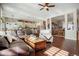 Spacious living room with hardwood floors, comfortable seating, and seamless flow to the kitchen at 7186 Weaver Cir, Castle Rock, CO 80104