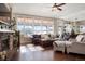 Bright living room with hardwood floors, large windows, comfortable seating, and a fireplace at 7186 Weaver Cir, Castle Rock, CO 80104
