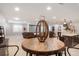 Open concept living space with bar area, tv room, round dining table, carpeted floor, and recessed lighting at 7186 Weaver Cir, Castle Rock, CO 80104