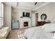 Cozy main bedroom featuring a fireplace, neutral tones, and soft natural light at 7186 Weaver Cir, Castle Rock, CO 80104