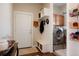 Mud room with bench and storage, coat hooks, and access to the laundry room with new appliances at 7186 Weaver Cir, Castle Rock, CO 80104