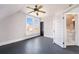 Upstairs bedroom with ceiling fan and ensuite bathroom access at 2219 W 33Rd Ave, Denver, CO 80211