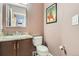Half bath featuring a vanity with granite countertop and toilet at 8300 Fairmount Dr # Aa102, Denver, CO 80247