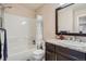 Bathroom features tiled shower and tub, stylish vanity with granite countertop, and modern fixtures at 8300 Fairmount Dr # Aa102, Denver, CO 80247