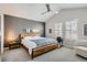 Bedroom with hardwood floors, a ceiling fan, side table with lamp, and a large bed at 8300 Fairmount Dr # Aa102, Denver, CO 80247