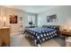 Bright bedroom features a desk and chair, large window, and decoratively hung artwork at 8300 Fairmount Dr # Aa102, Denver, CO 80247