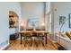 Formal dining room featuring hardwood floors, modern furniture, and plenty of natural light from large windows at 8300 Fairmount Dr # Aa102, Denver, CO 80247