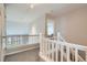 Hallway with white railing overlooks the lower level of the house at 8300 Fairmount Dr # Aa102, Denver, CO 80247