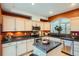 Modern kitchen with stainless steel appliances, granite countertops, and a center island for additional workspace at 8300 Fairmount Dr # Aa102, Denver, CO 80247