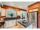 Contemporary kitchen with stainless steel appliances, granite countertops, and ample cabinet storage at 8300 Fairmount Dr # Aa102, Denver, CO 80247