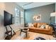 Living room features wood floor, stylish lighting, and comfortable seating at 8300 Fairmount Dr # Aa102, Denver, CO 80247