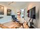 Comfortable living room with hardwood floors, artistic decor, and an open doorway leading to the kitchen at 8300 Fairmount Dr # Aa102, Denver, CO 80247