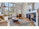 Bright living room with large windows, vaulted ceilings, modern fireplace, and stylish contemporary furnishings at 8300 Fairmount Dr # Aa102, Denver, CO 80247