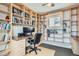 Office with custom built-in bookshelves, a desk, and a comfortable work space at 8300 Fairmount Dr # Aa102, Denver, CO 80247