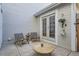 Charming outdoor patio with comfortable seating, a small table, and a hanging plant at 8300 Fairmount Dr # Aa102, Denver, CO 80247