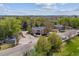 A neighborhood shot of the home shows green trees and other houses in the area at 1160 S Clinton St # 40, Denver, CO 80247
