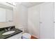 Bathroom featuring dark marble counters, white cabinetry, and flooring at 1160 S Clinton St # 40, Denver, CO 80247