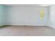 Well-lit bedroom with neutral carpet, a small window, and light blue walls at 1160 S Clinton St # 40, Denver, CO 80247
