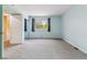 Light filled bedroom with plush carpet and window with forest view at 1160 S Clinton St # 40, Denver, CO 80247
