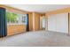 Bedroom with blue curtains and view outside a large window, door and closet at 1160 S Clinton St # 40, Denver, CO 80247