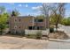 Charming two-story townhome with manicured lawn and mature trees, complete with For Sale sign at 1160 S Clinton St # 40, Denver, CO 80247