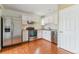 Bright kitchen featuring stainless steel appliances, white cabinets, and wood-look flooring at 1160 S Clinton St # 40, Denver, CO 80247
