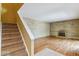 Cozy living room with hardwood floors, brick wall and fireplace, with nearby stairs at 1160 S Clinton St # 40, Denver, CO 80247