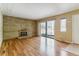 Inviting living area with beautiful floors, brick fireplace, and sliding doors for natural light at 1160 S Clinton St # 40, Denver, CO 80247