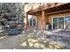 Backyard features covered patio with sliding glass doors and a mature blue spruce at 8822 Fiesta Ter, Lone Tree, CO 80124