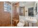 Updated bathroom showcasing tiled walk-in shower, glass block window, and floating sink at 8822 Fiesta Ter, Lone Tree, CO 80124