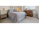 Cozy bedroom with natural light, comfortable bed, and vintage wooden dresser at 8822 Fiesta Ter, Lone Tree, CO 80124