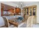 Dining area featuring a glass table, wood chairs and a view into the well-lit kitchen at 8822 Fiesta Ter, Lone Tree, CO 80124