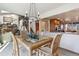 Bright dining area with a glass table and a view into a modern kitchen space at 8822 Fiesta Ter, Lone Tree, CO 80124