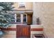 Charming entry featuring a custom wood gate, brick accents, and a cozy bay window at 8822 Fiesta Ter, Lone Tree, CO 80124