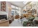 Bright and airy living room featuring a fireplace, large windows, and comfortable seating arrangements at 8822 Fiesta Ter, Lone Tree, CO 80124